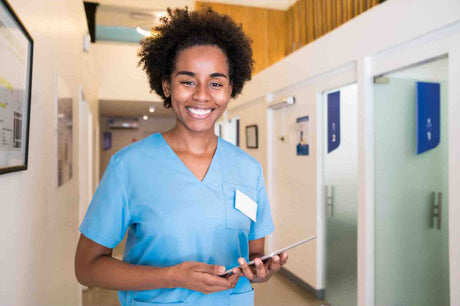 An image of a lady holding an iPad. This is an image for this blog post about iPad use in healthcare